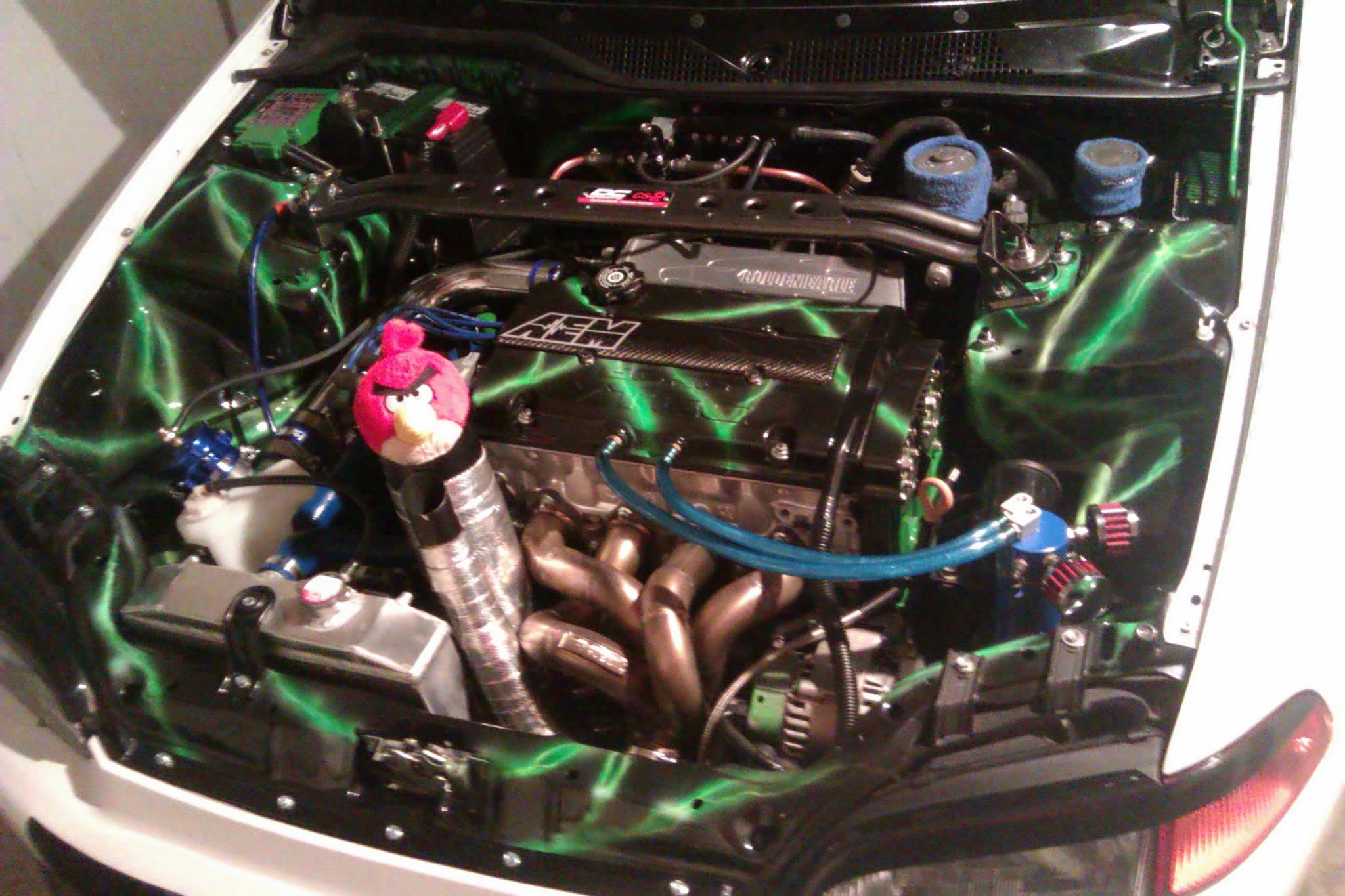 Custom green and black performance engine bay